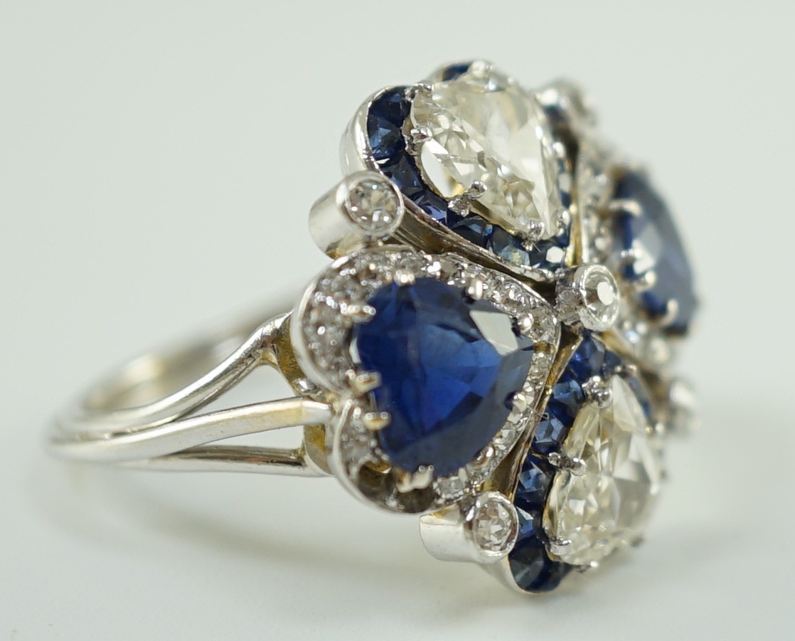 An attractive 18ct white gold, two stone heart shaped diamond and two stone heart shaped sapphire set cluster ring